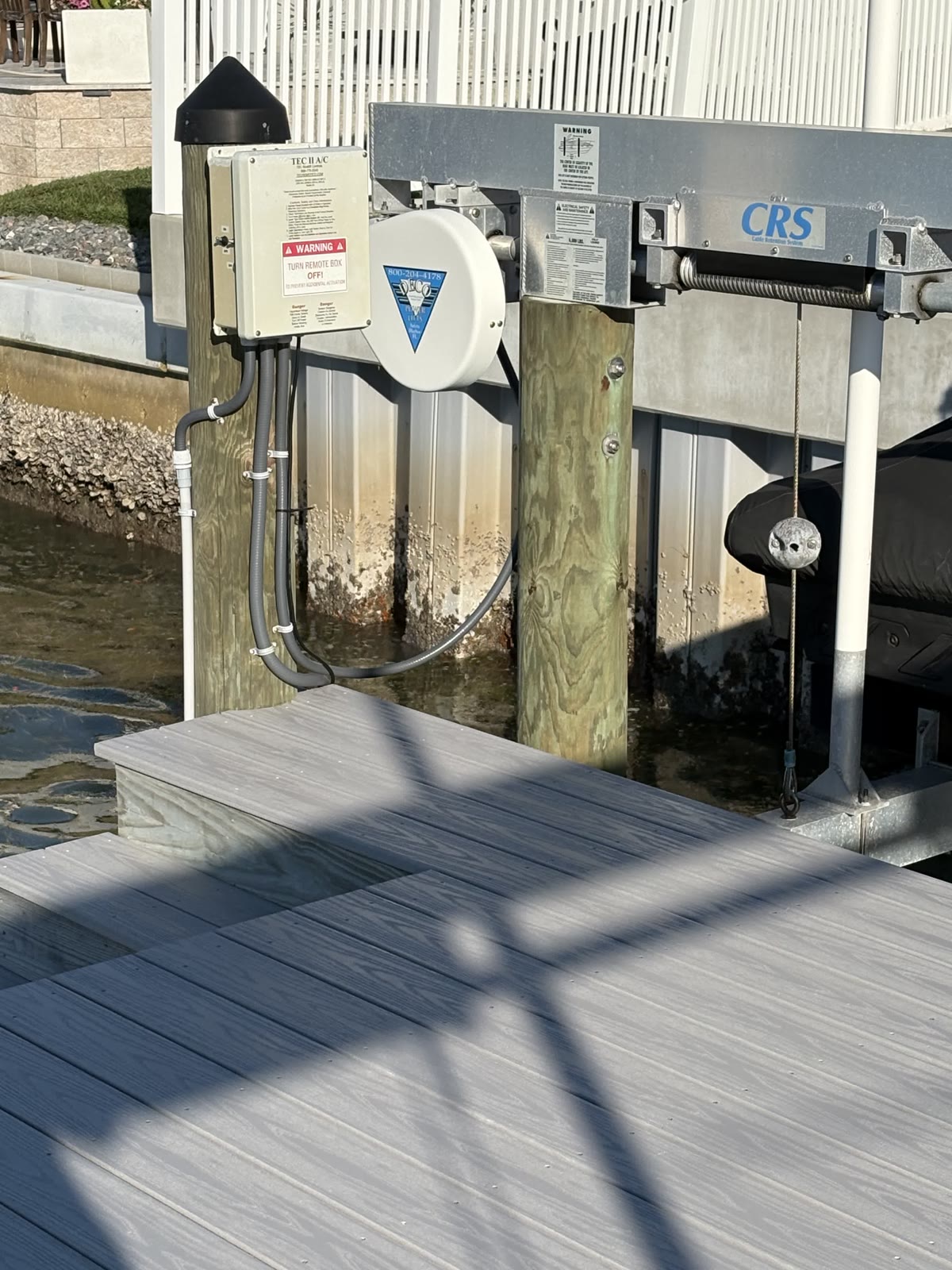 Weatherproof boat lift control box mounted on a dock piling in Dunedin, FL