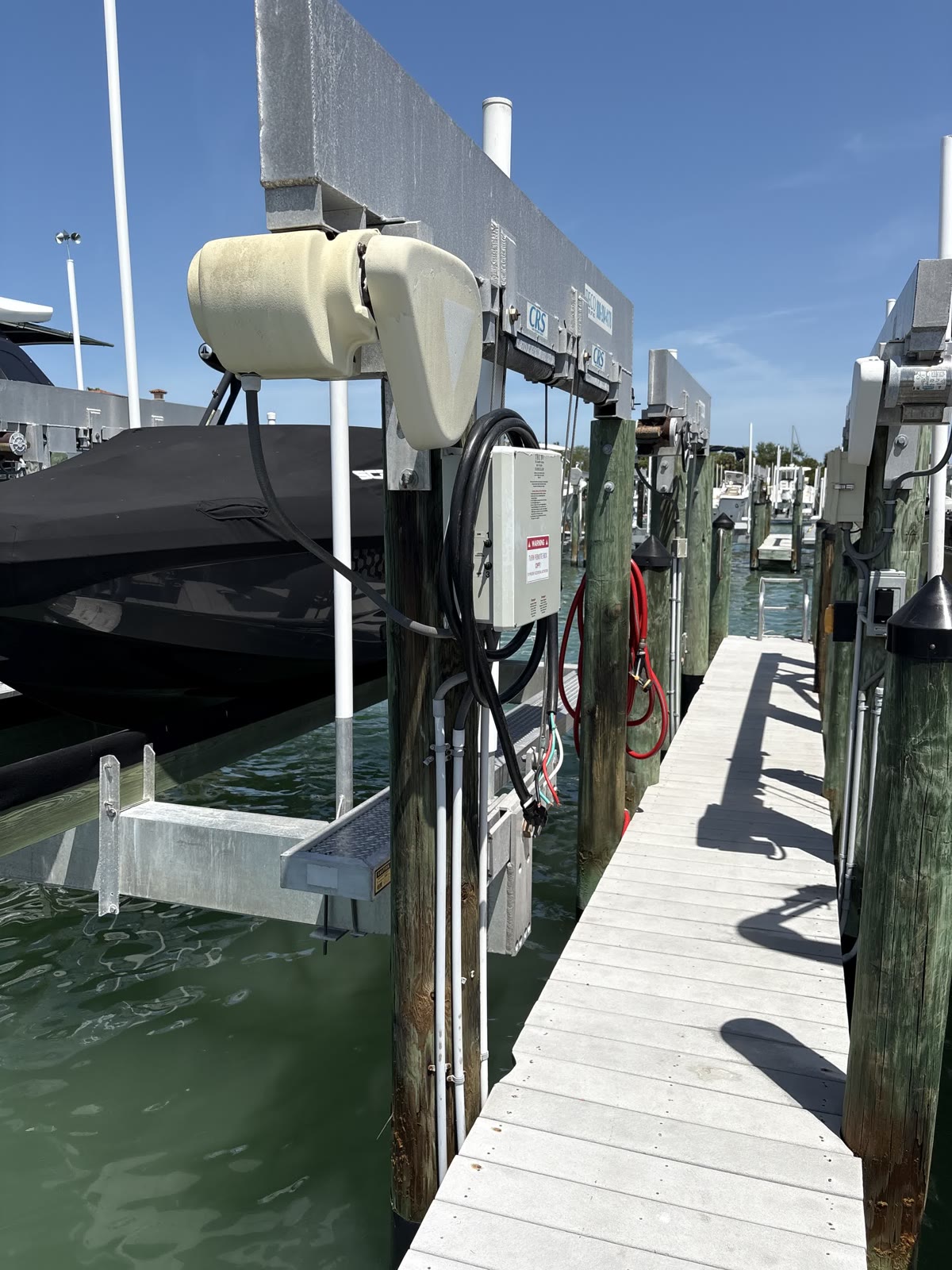 Boat lift wiring and conduit run along a private dock in Tampa Bay