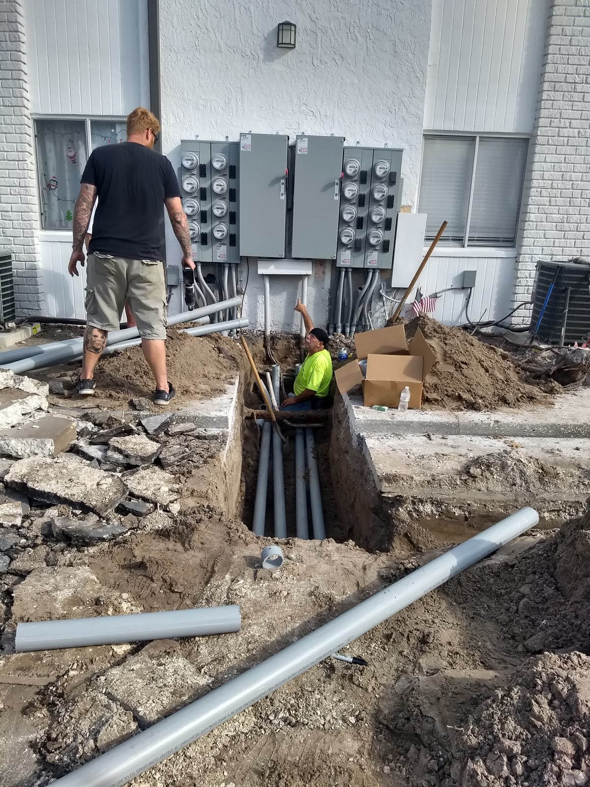 Brightwire electricians running underground conduit to a commercial meter bank