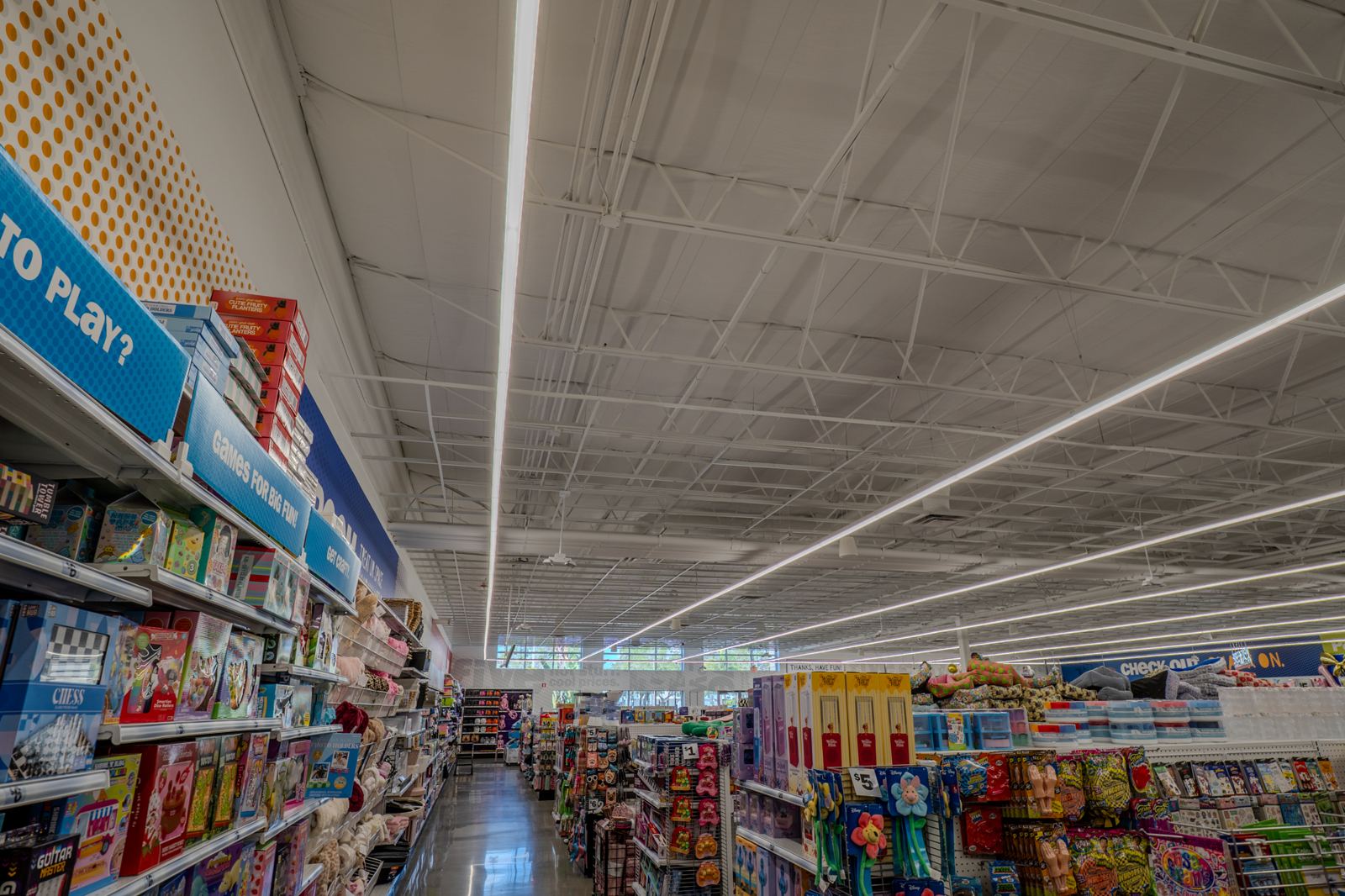 Retail aisles under linear LED lighting, a Brightwire Electric project