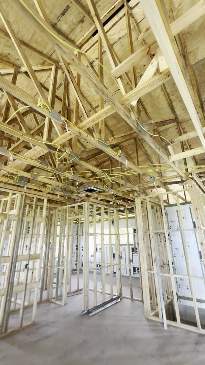 New wiring run through the roof trusses of a two-story home by Brightwire Electric